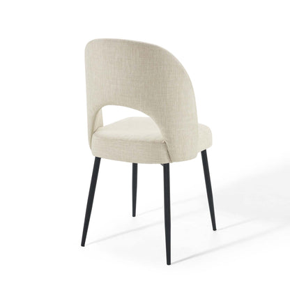 Beige upholstered dining side chair with rounded back and black tapered metal legs.