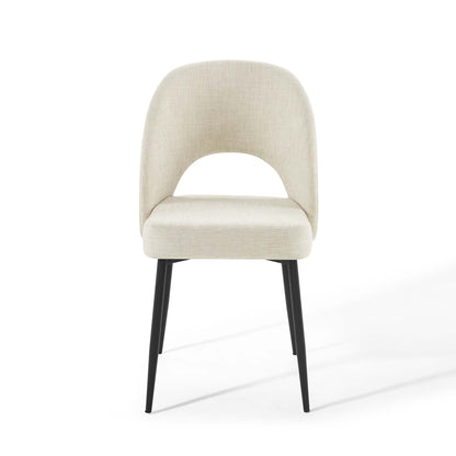 Beige fabric dining chair with rounded back, curved arm opening, cushioned seat, and black tapered legs.