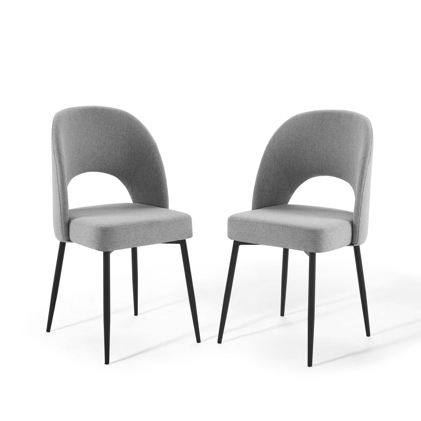 Pair of gray upholstered dining chairs with curved backs featuring an open arc cutout and black tapered legs.