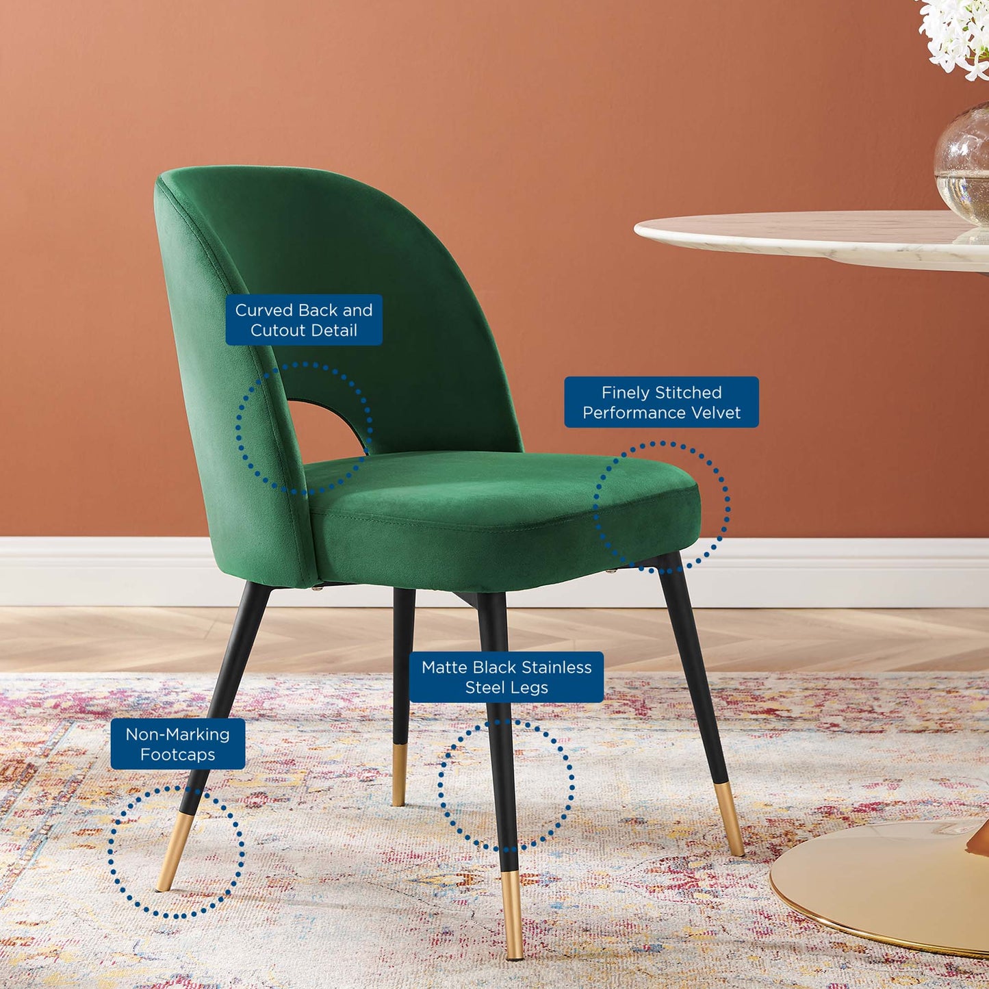 Emerald green velvet dining chairs set of 2 with curved back, cutout detail, matte black stainless legs and non-marking footcaps.