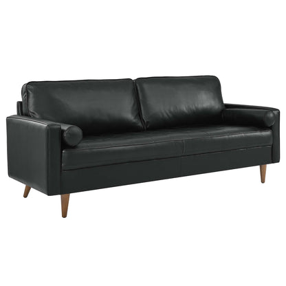 Black leather sofa in mid-century modern style with two seat cushions, cylindrical left bolster, and tapered wooden legs.