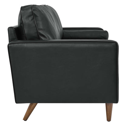 Black leather sofa with cushioned back, straight arms, and wooden tapered legs; mid-century modern style.