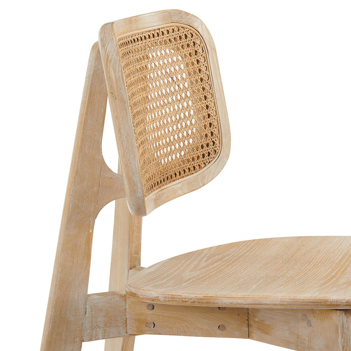 Gray wood dining side chair with a woven cane backrest and a rounded seat in a light, distressed finish.