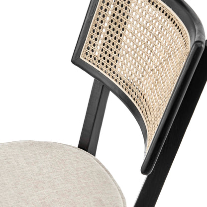 Black wood dining chair with woven cane back & beige fabric seat.