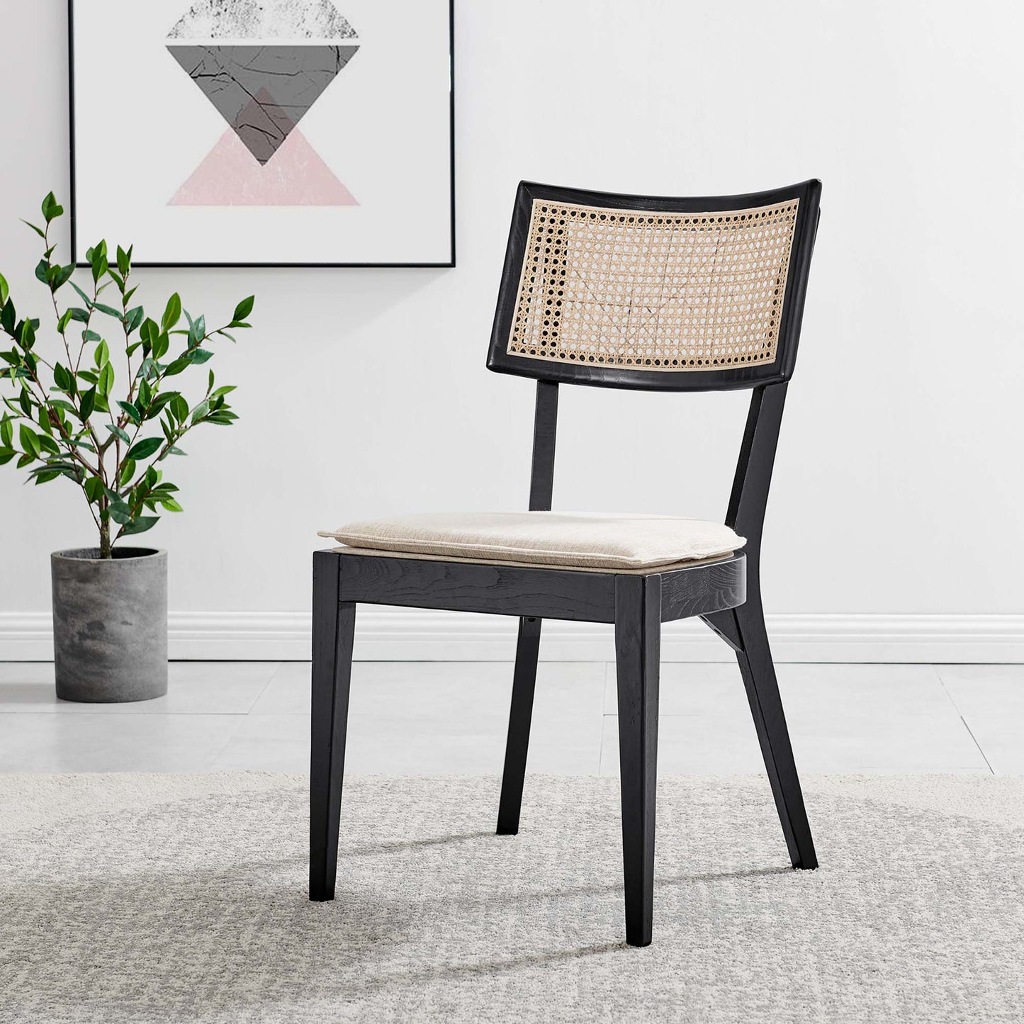 Black wooden dining chair with a caned backrest and beige cushion, modern Nordic-style living room decor.