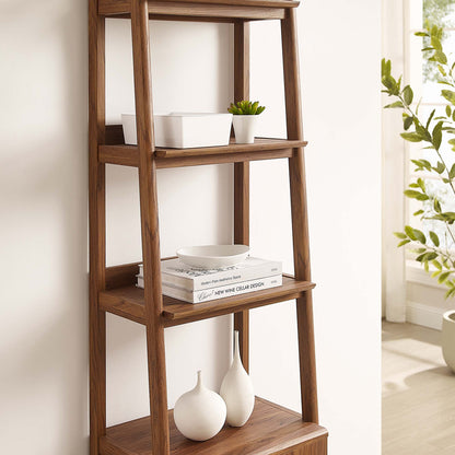 Walnut-finish wooden bookshelf with 4 shelves, holding white bowls, books, a small plant, and ceramic vases.
