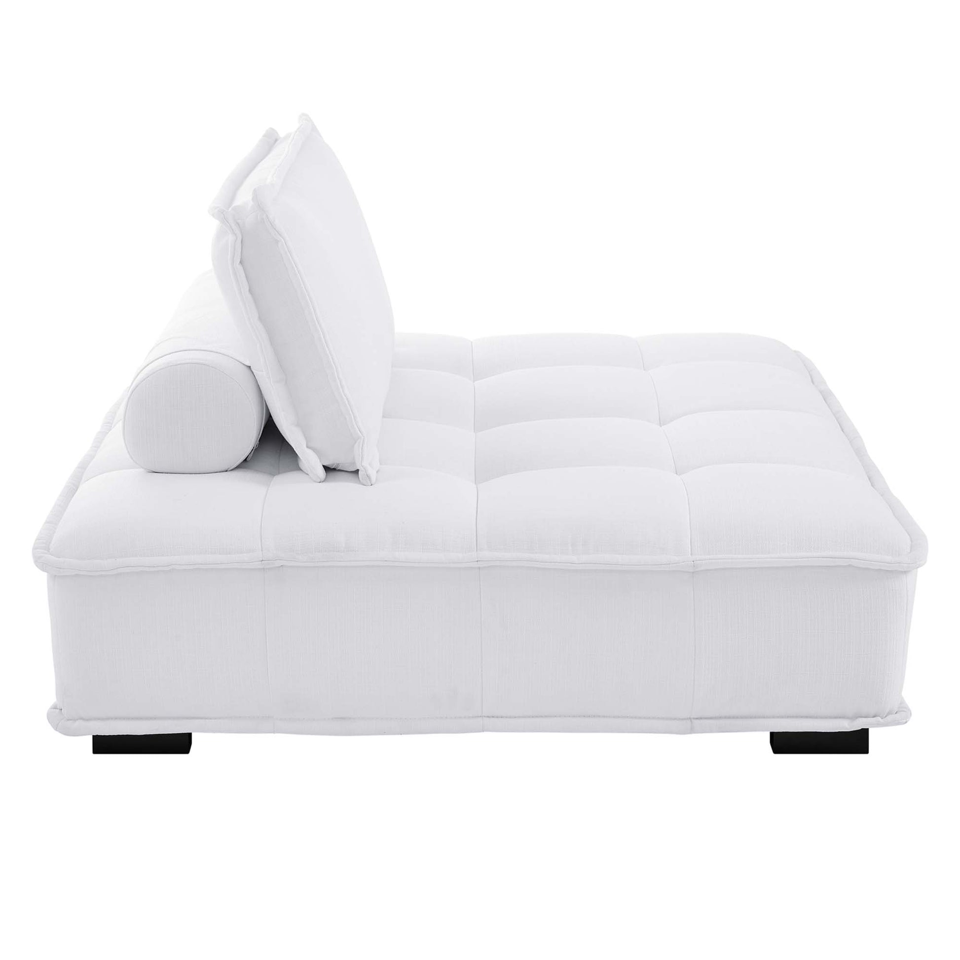White tufted fabric armless chair with a low-profile square silhouette on short black legs.