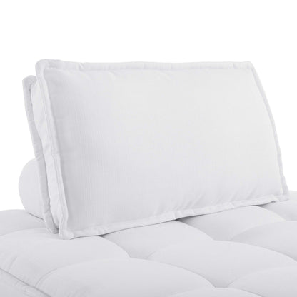 White armless tufted fabric chair with piped edges.