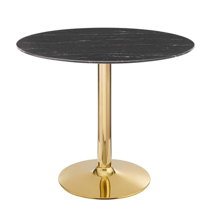 Round black marble top dining table with a gold metal pedestal and circular base.