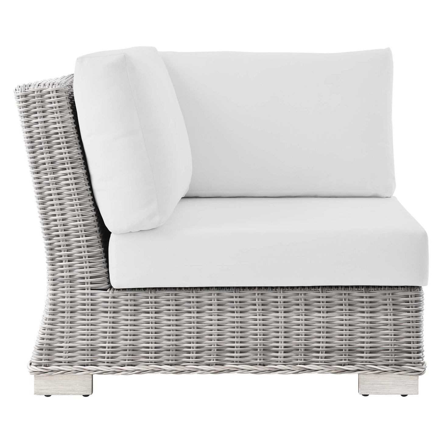 Gray wicker outdoor corner chair with white seat and back cushions and a matching throw pillow.