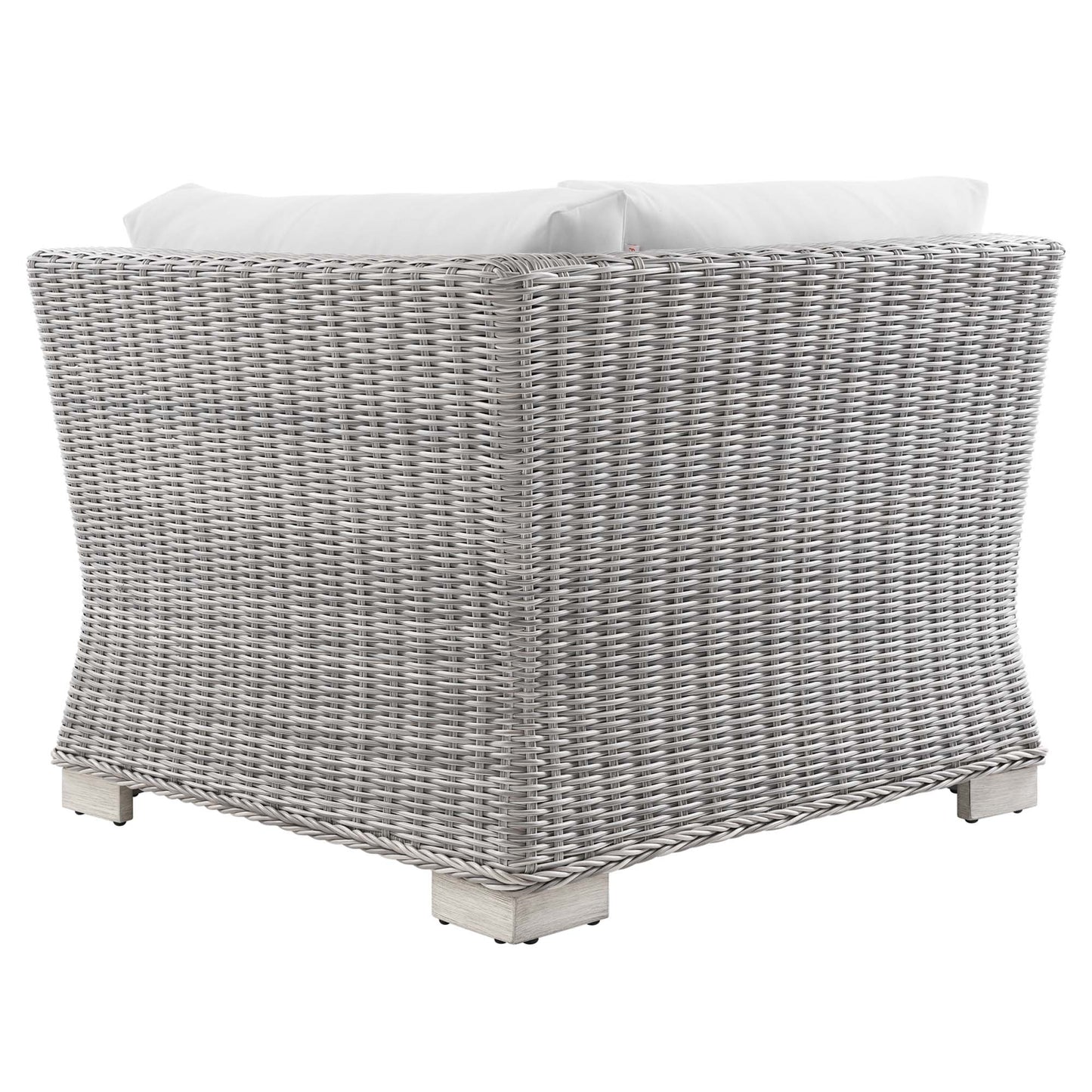 Light gray woven wicker outdoor corner chair with white cushions and pale wooden feet.