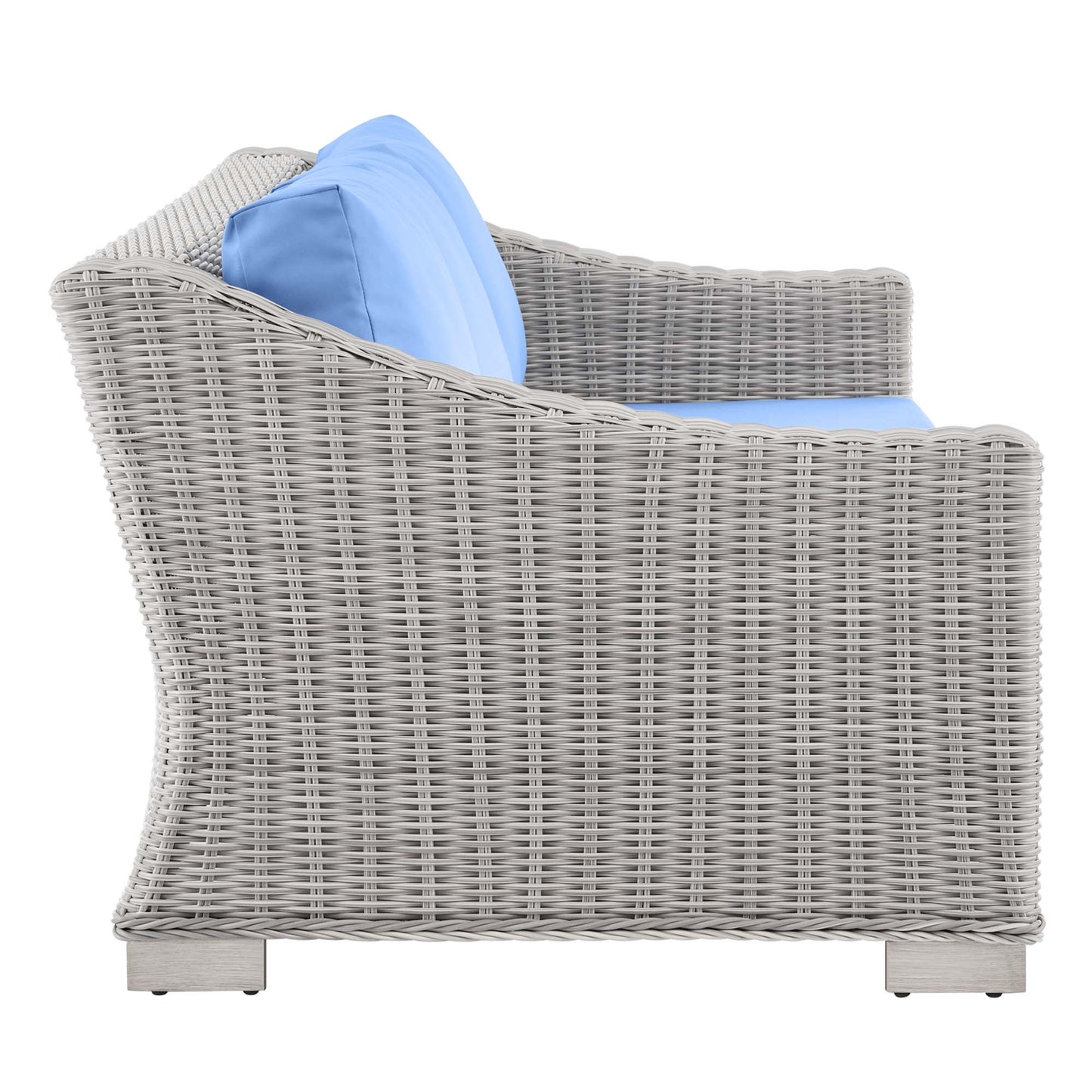 Light gray wicker outdoor sofa with light blue cushions, curved back and arms, square base—patio lounge seating.