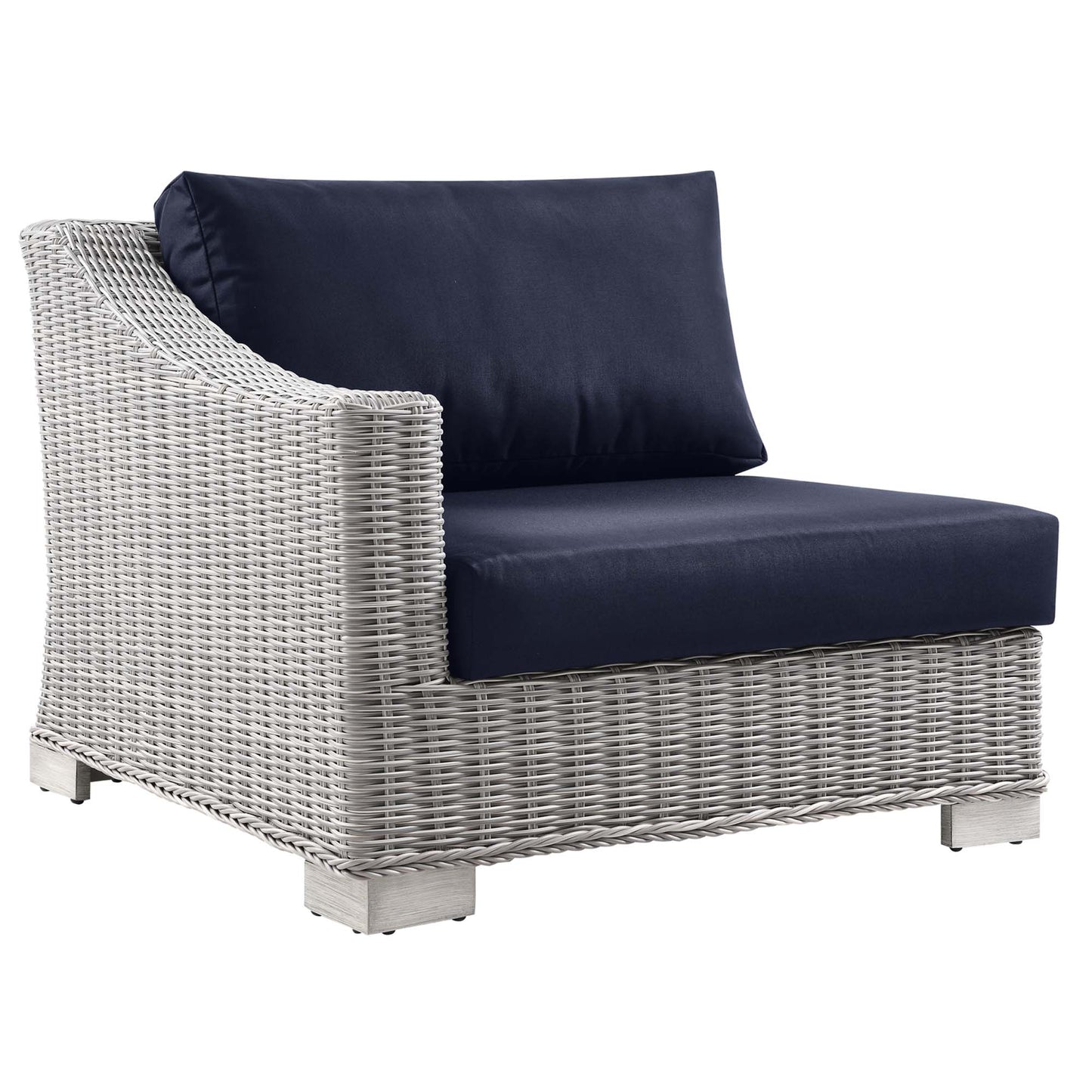 Light gray wicker outdoor armchair with navy cushions, modern patio seating.