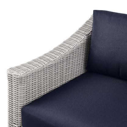 Light gray wicker outdoor left-arm chair with navy cushions