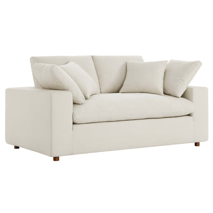 Beige linen loveseat with square arms, plush back cushions, matching throw pillows, and wooden feet.
