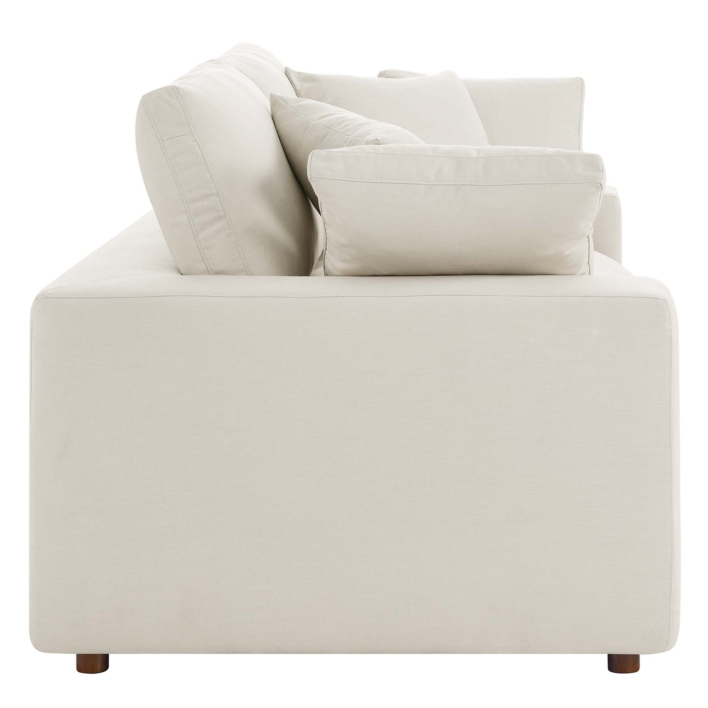 Beige fabric loveseat with square arms, loose cushions, and short wooden feet; modern, boxy living room seating.