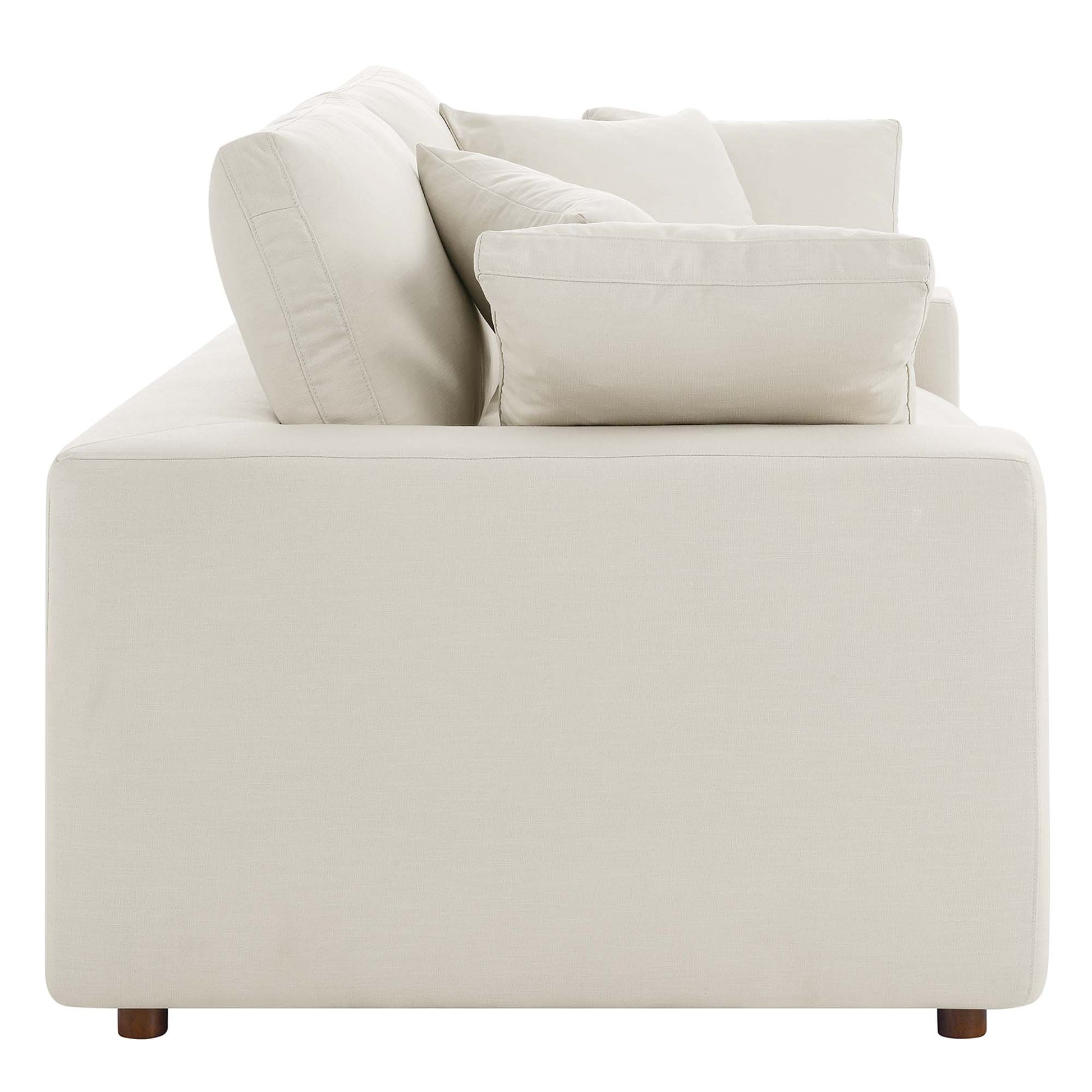 Beige fabric loveseat with square arms, loose cushions, and short wooden feet; modern, boxy living room seating.