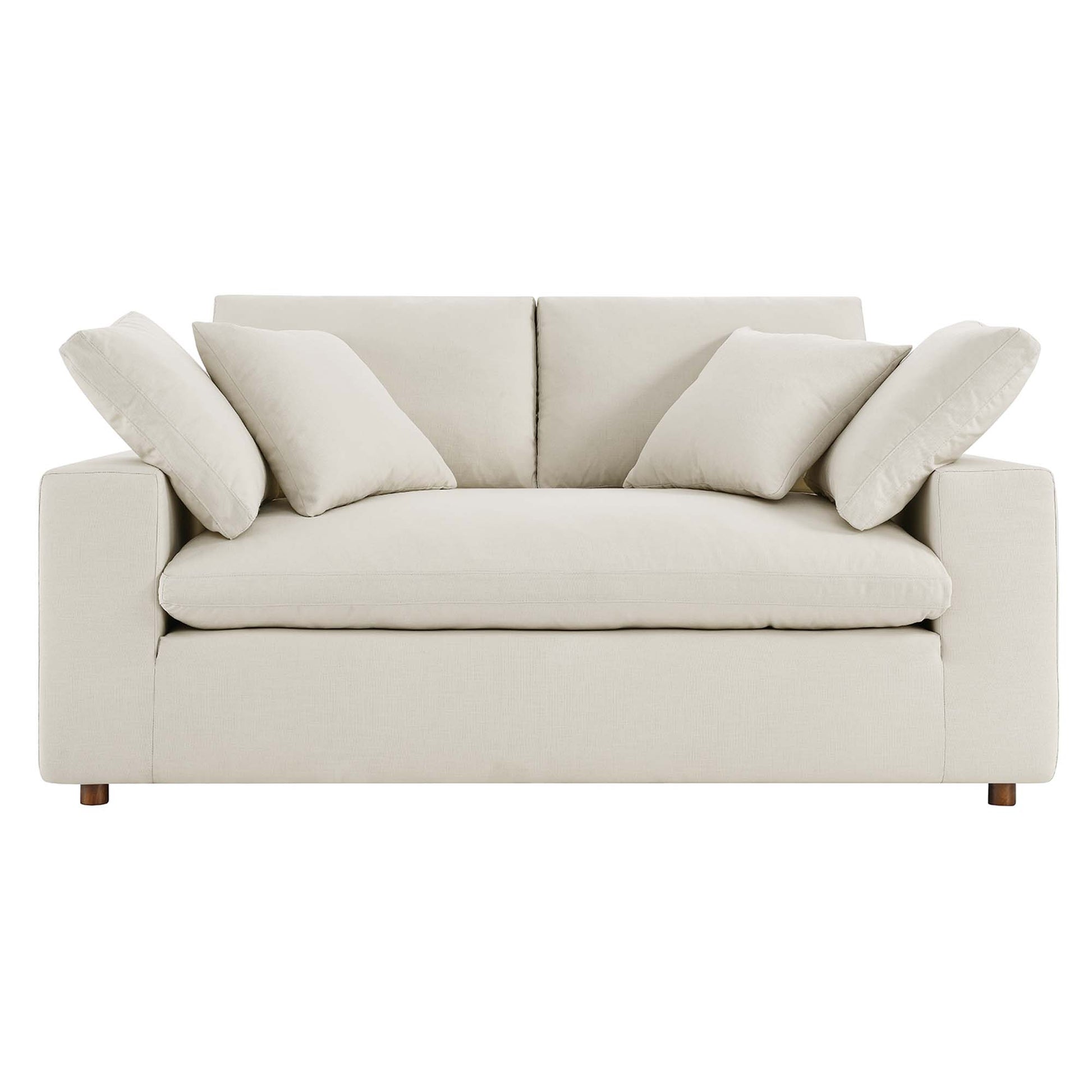 Light beige fabric loveseat with square arms and wooden feet, plush back cushions and coordinating throw pillows.