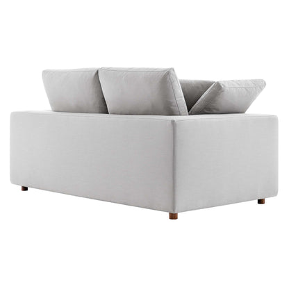 Light gray fabric loveseat with boxy arms, two back cushions and short wooden legs.