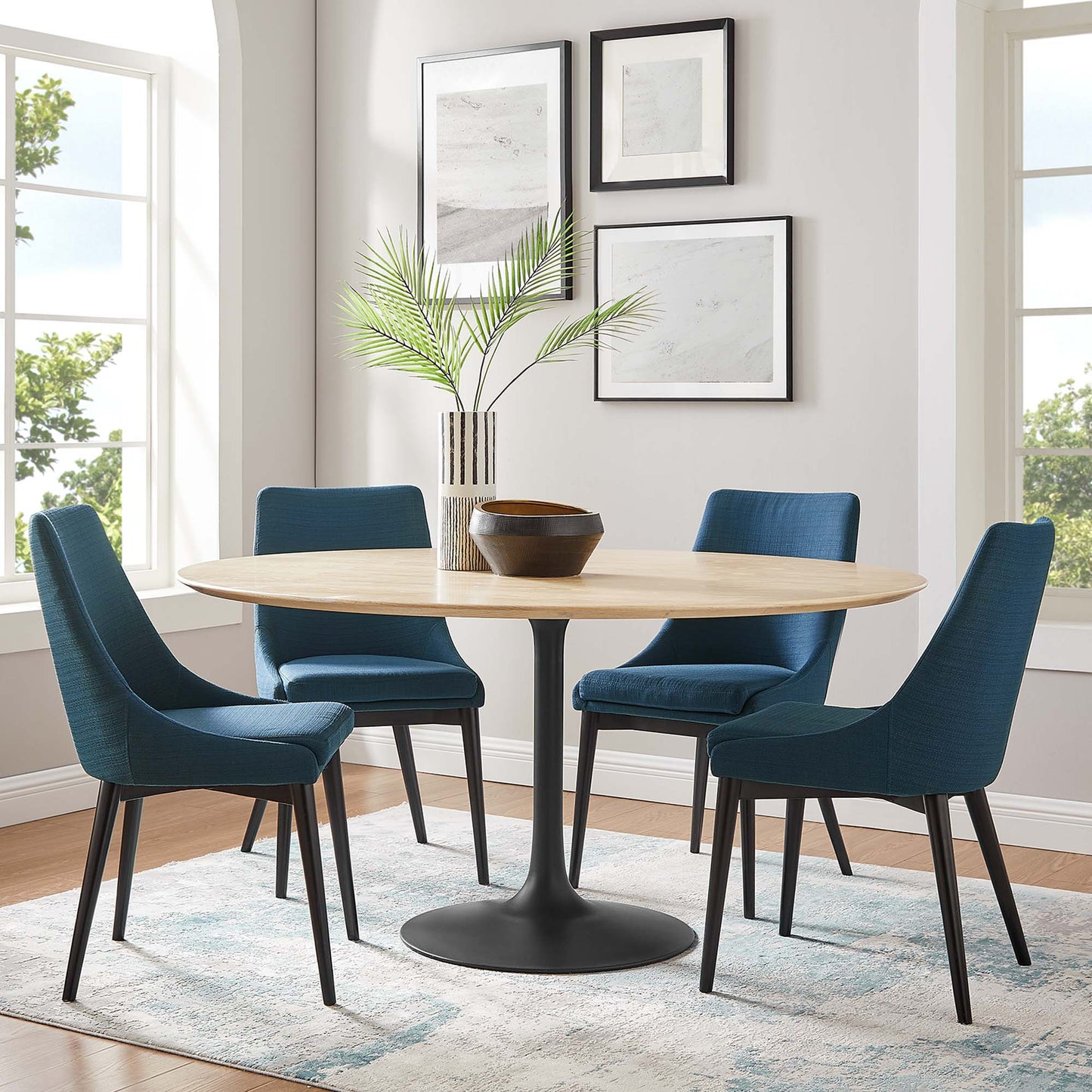 60" round natural wood dining table with a black pedestal base.