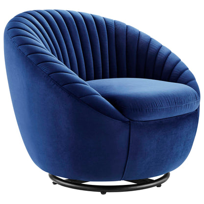 Navy blue velvet tufted swivel chair with curved back and round metal base.