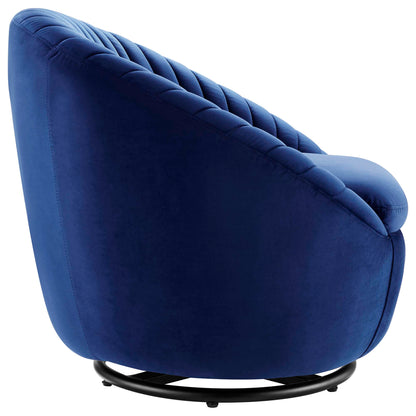 Navy blue velvet swivel lounge chair with tufted back, rounded silhouette and black metal circular base.
