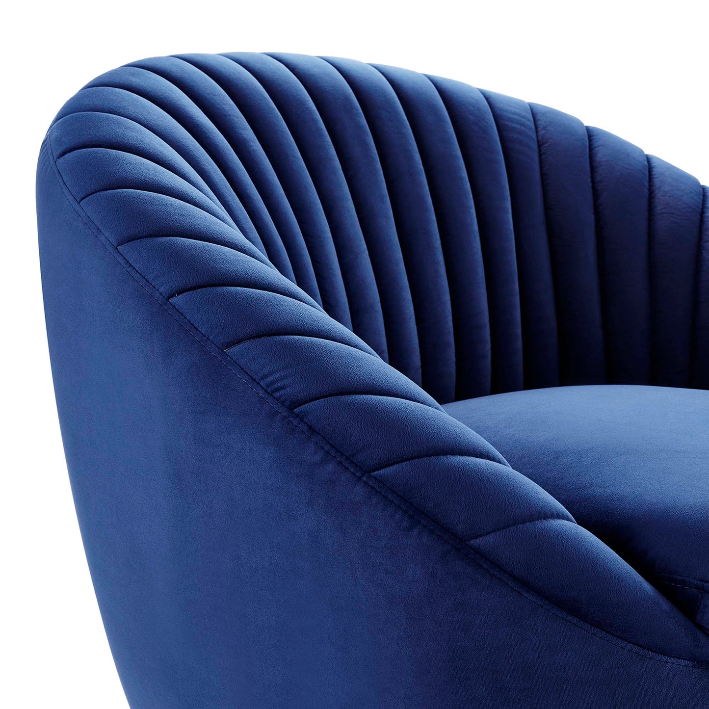 Navy blue velvet curved tufted swivel chair with vertical channel tufting.