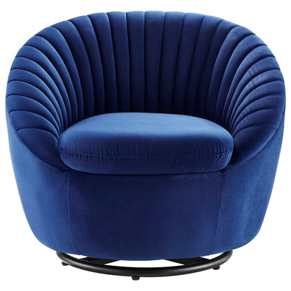 Navy blue velvet swivel round accent chair with vertical channel tufting and a black circular metal base