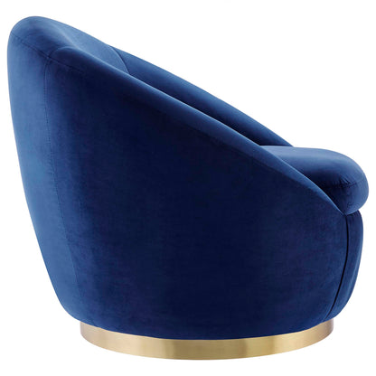 Navy blue velvet lounge chair with curved back and gold-tone circular base.