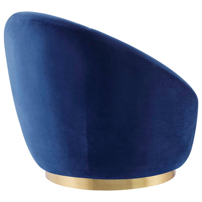 Navy blue velvet swivel chair with curved back and gold metal pedestal base.
