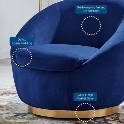 Navy blue velvet swivel chair with dense foam padding, curved silhouette, and a gold metal base.