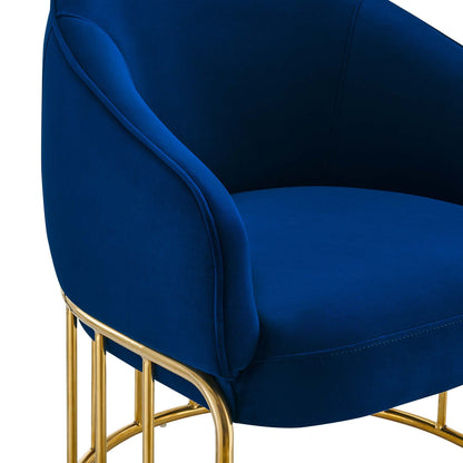 Navy blue velvet armchair with curved arms and tubular gold metal frame, glam modern style.