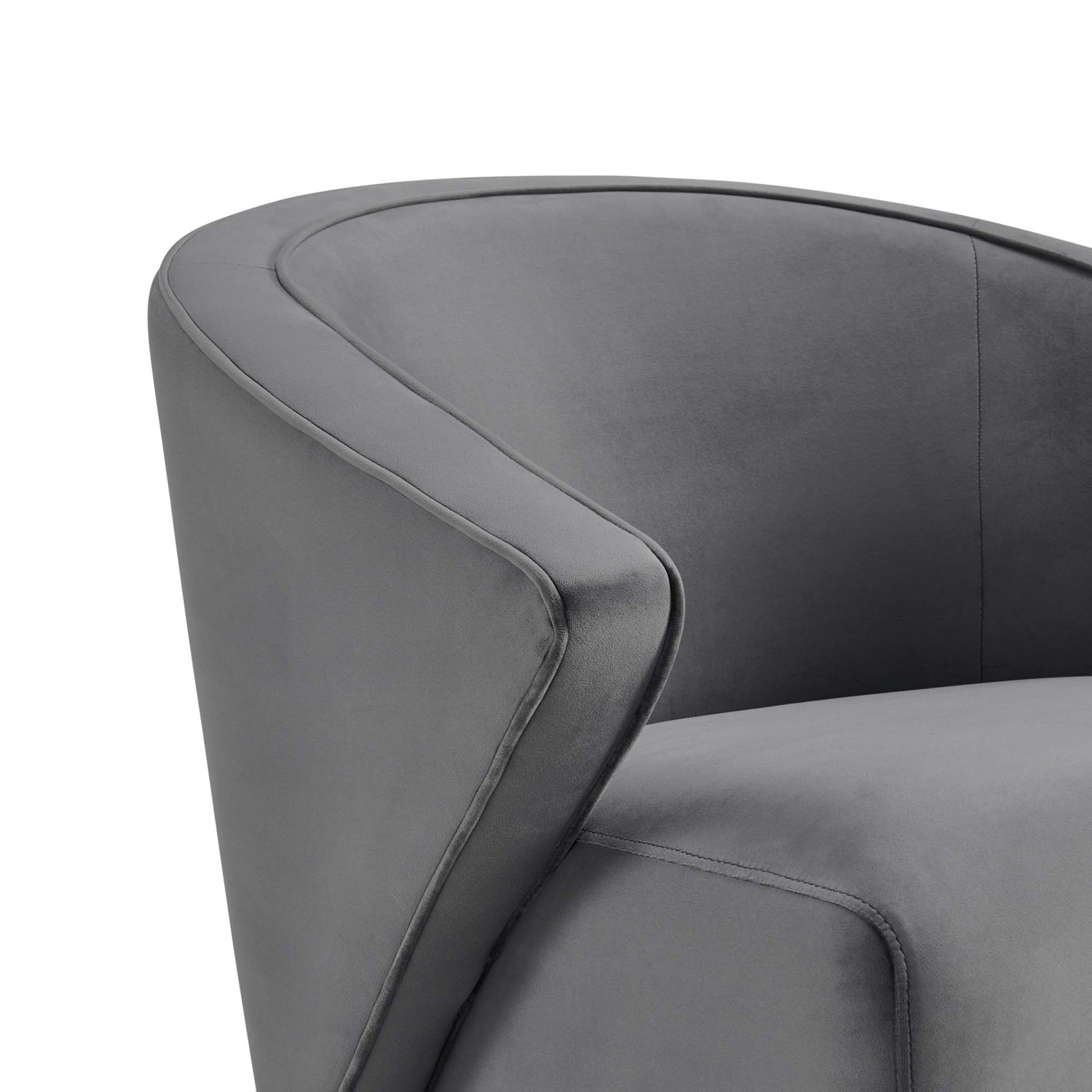 Charcoal gray curved-arm velvet armchair with visible stitching.