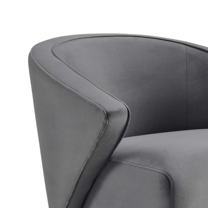 Charcoal gray curved-arm velvet armchair with visible stitching.