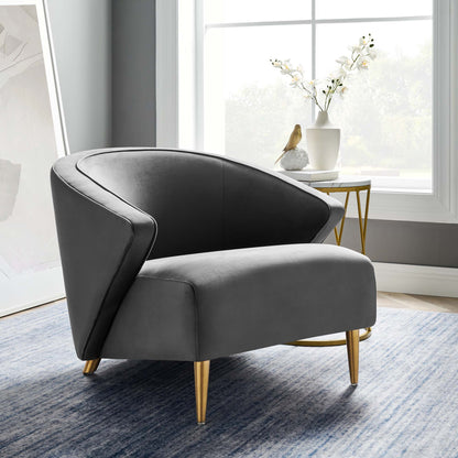 Two-tone gray curved barrel armchair with gold tapered legs in a bright modern living room.