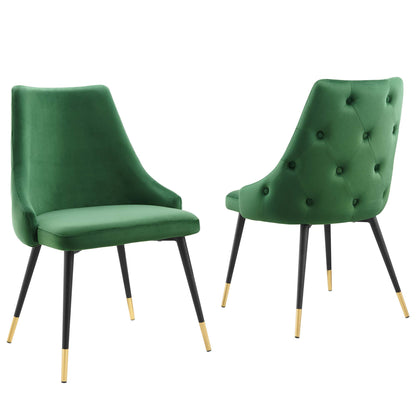 Emerald green velvet accent chairs with black legs and gold-tipped feet; one tufted back and one smooth back.