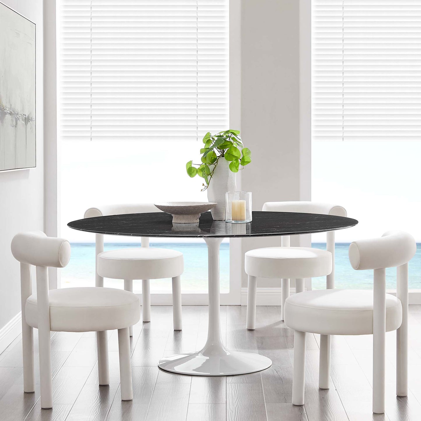 White mid-century round faux-marble dining table with white pedestal base.