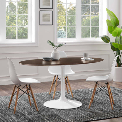 Oval cherry walnut wood dining table, surrounded by white molded chairs with wooden legs on a gray rug.