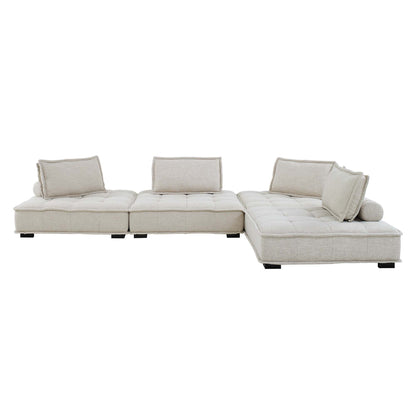 Brown fabric modular sectional sofa with chaise & tufted cushions, back pillows, low dark legs.
