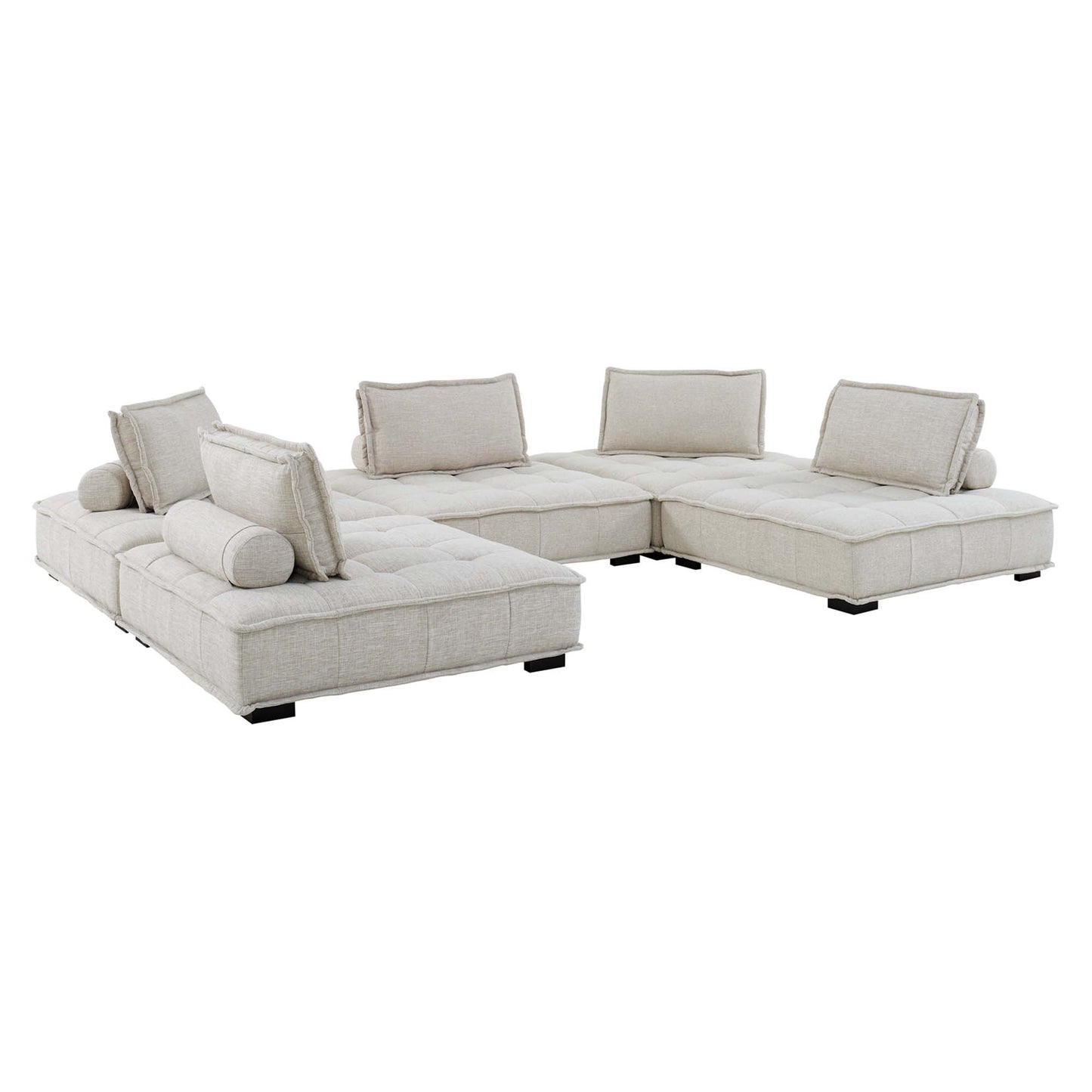 Beige tufted fabric sectional sofa in an L-shape with loose back cushions and cylindrical bolsters.