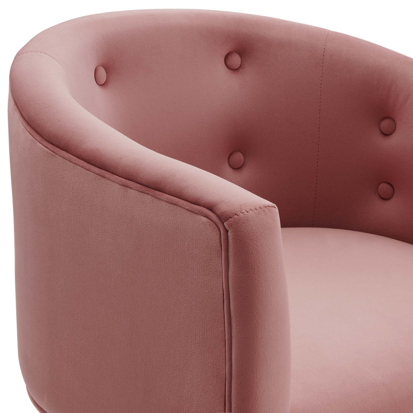 Blush pink velvet curved lounge chair with button tufting on backrest & rounded arms.