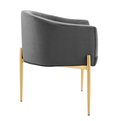 Grey velvet curved-back lounge chair with slender gold-tone legs, modern mid-century style.