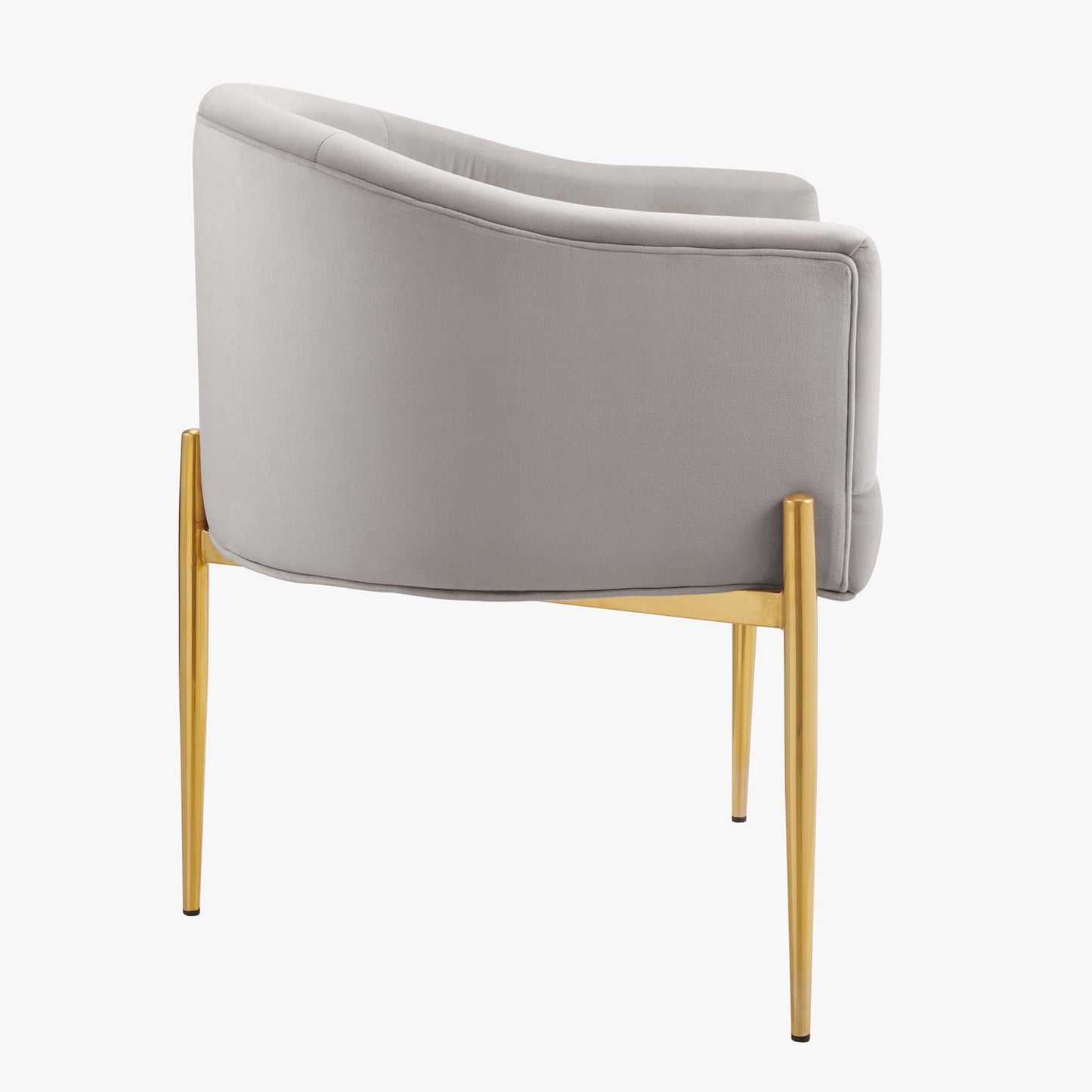 Grey curved-back lounge chair with soft fabric upholstery and gold tapered legs; modern accent seating.
