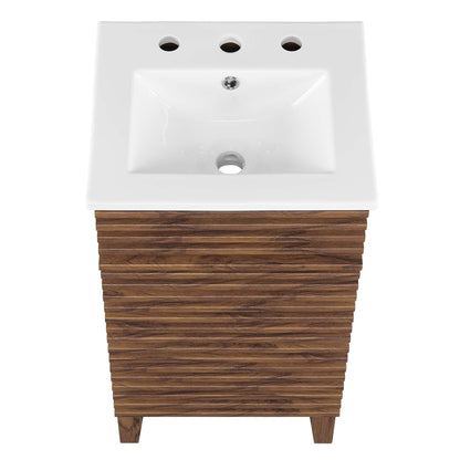 White rectangular ceramic bathroom sink atop a white bathroom vanity cabinet.