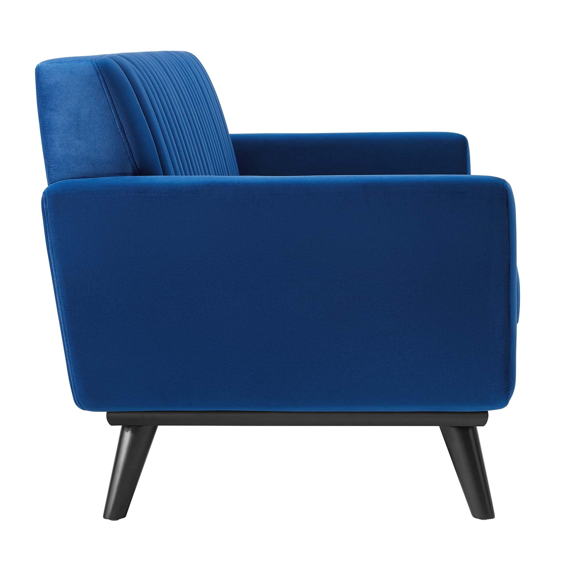 Navy velvet loveseat in mid-century modern style with channel-tufted back, square arms, and angled black legs.