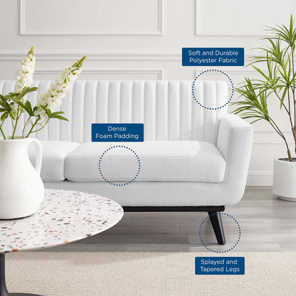 White loveseat with dense foam padding, soft durable polyester fabric, and splayed, tapered legs in a modern living room.