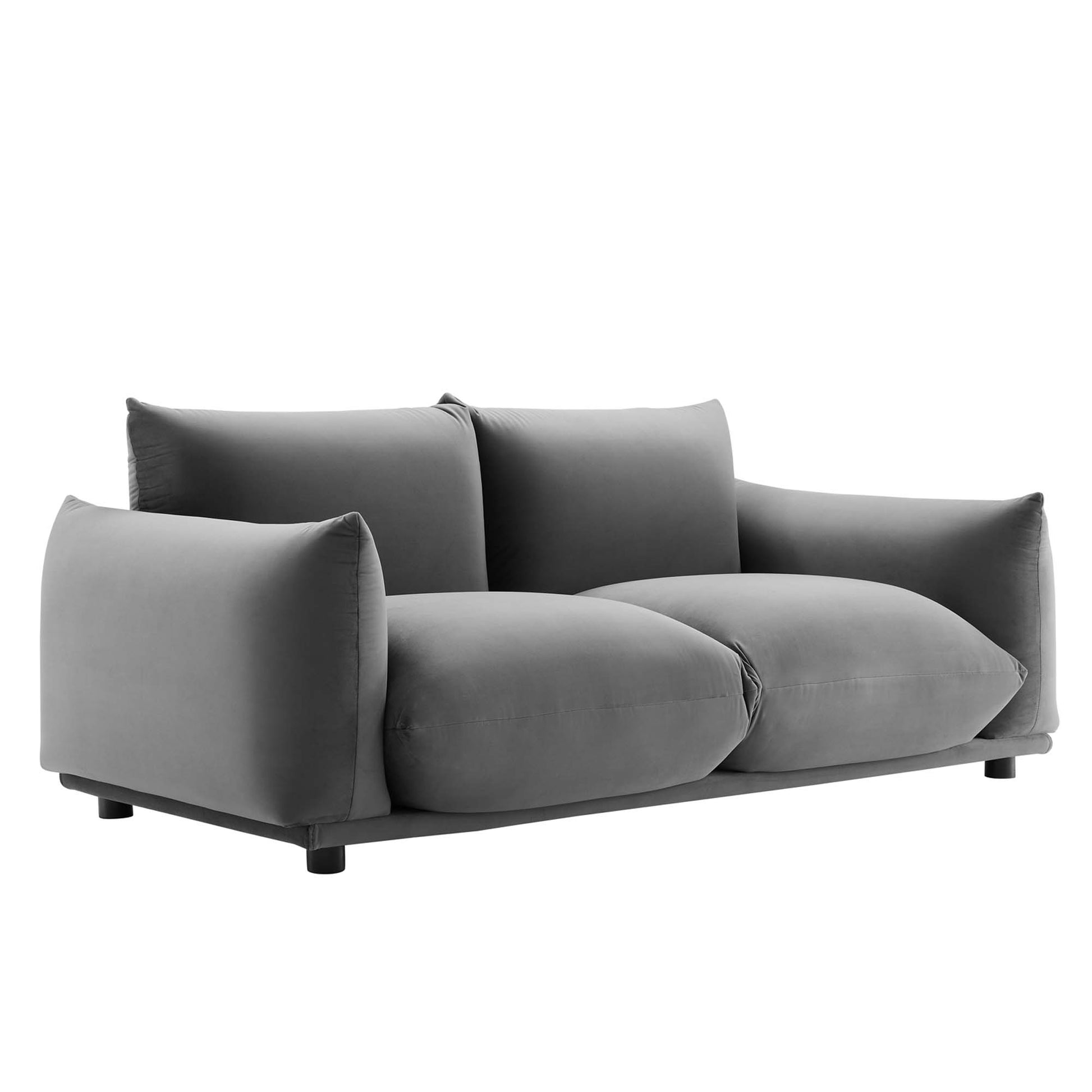Grey velvet loveseat with oversized cushions, low arms and black legs for a modern living room.