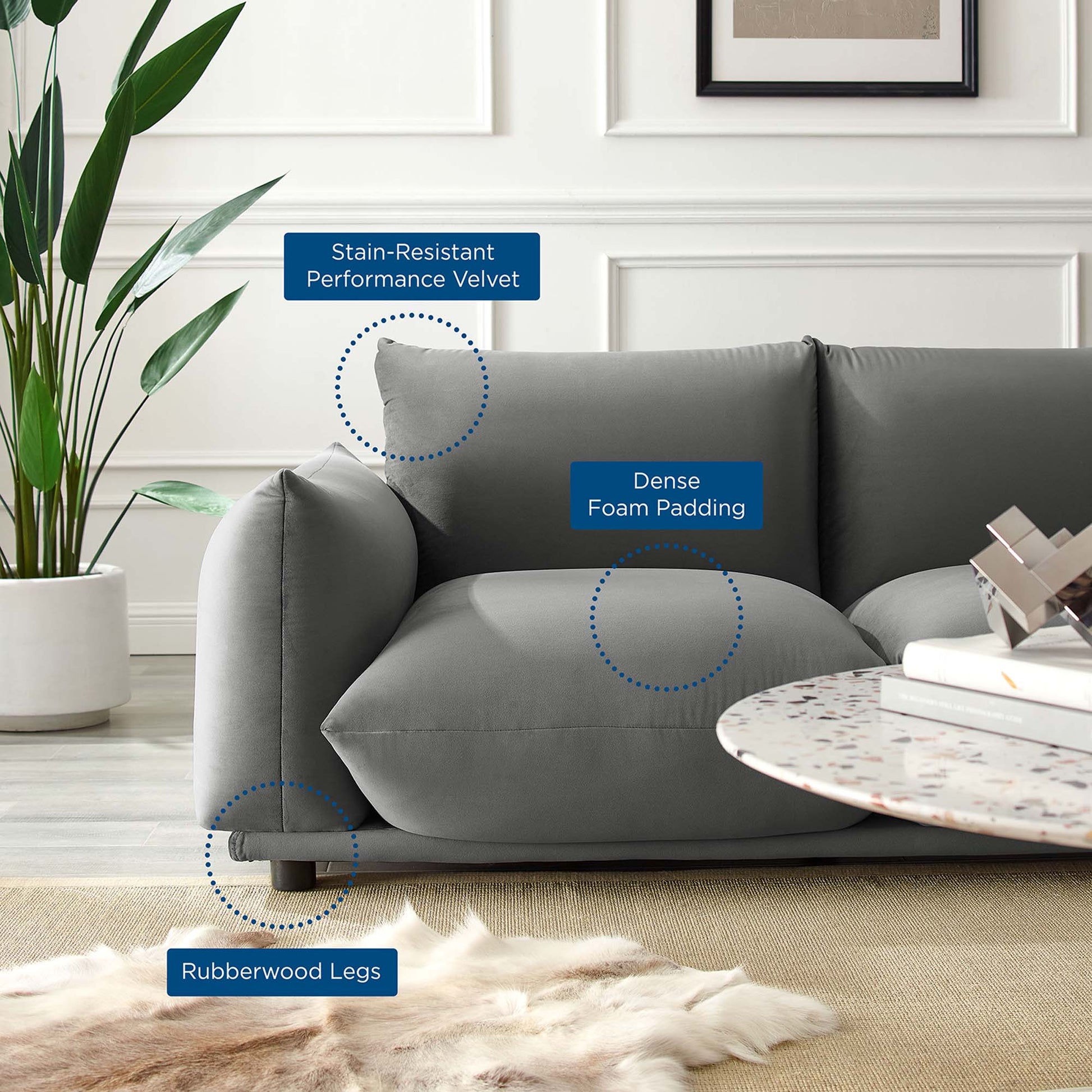 Gray velvet loveseat with stain-resistant performance fabric, dense foam cushions and rubberwood legs; contemporary living room.