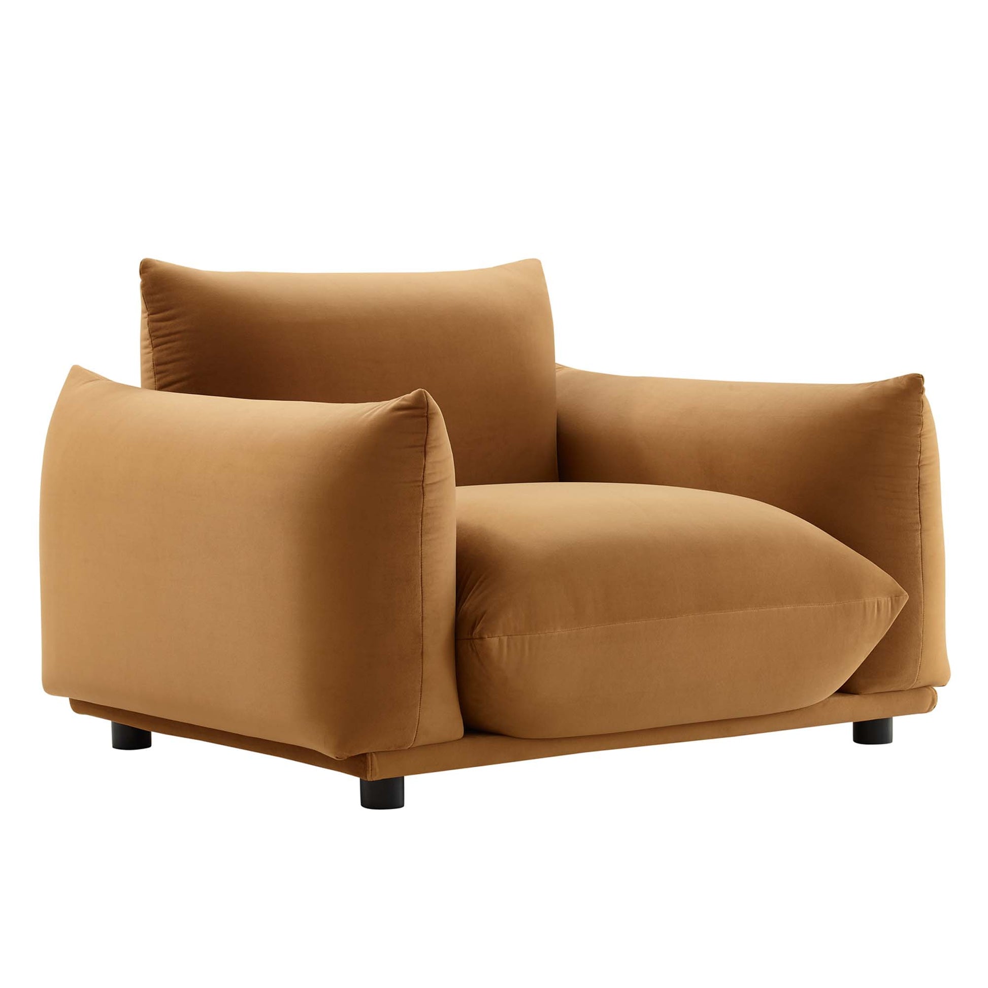 Caramel brown velvet fabric armchair with thick square cushions, low boxy silhouette and short black feet.