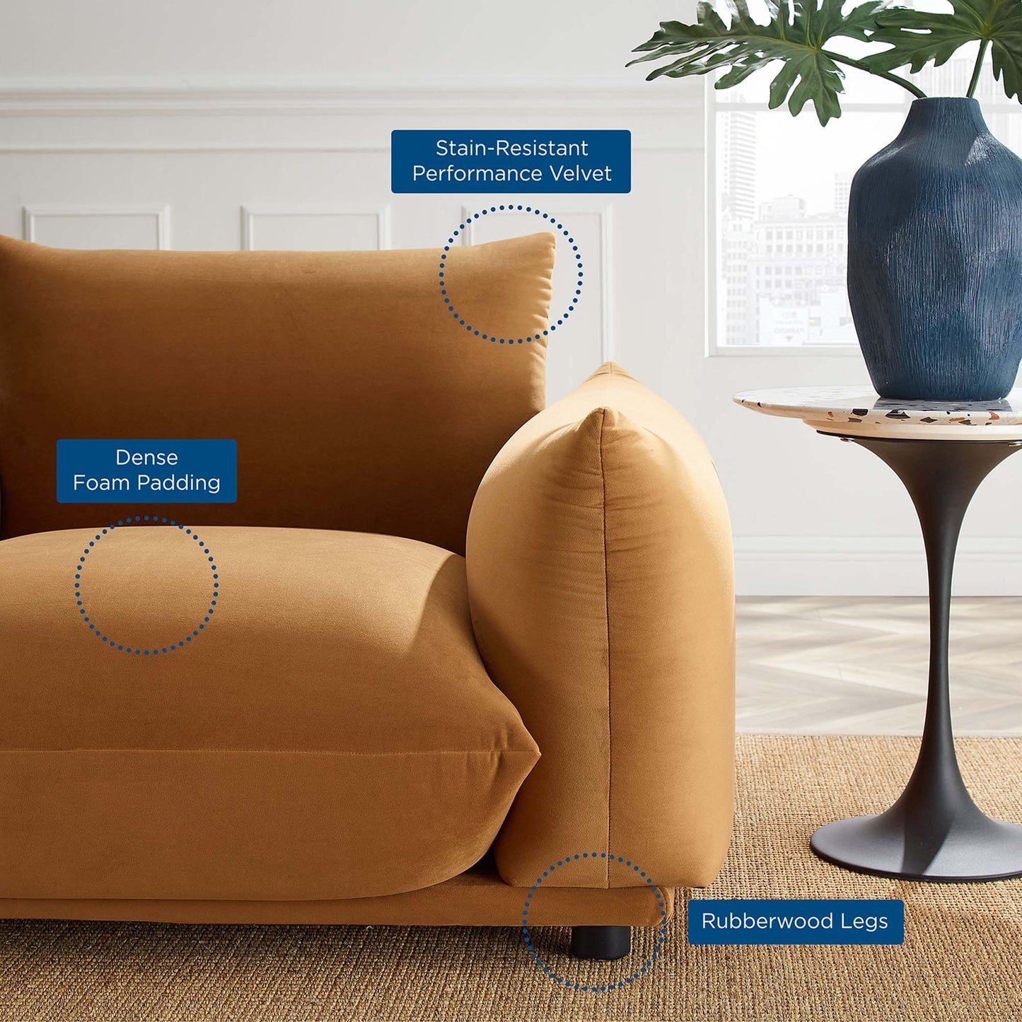 Cognac performance velvet armchair with dense foam padding, stain-resistant velvet, and rubberwood legs in a modern living room.